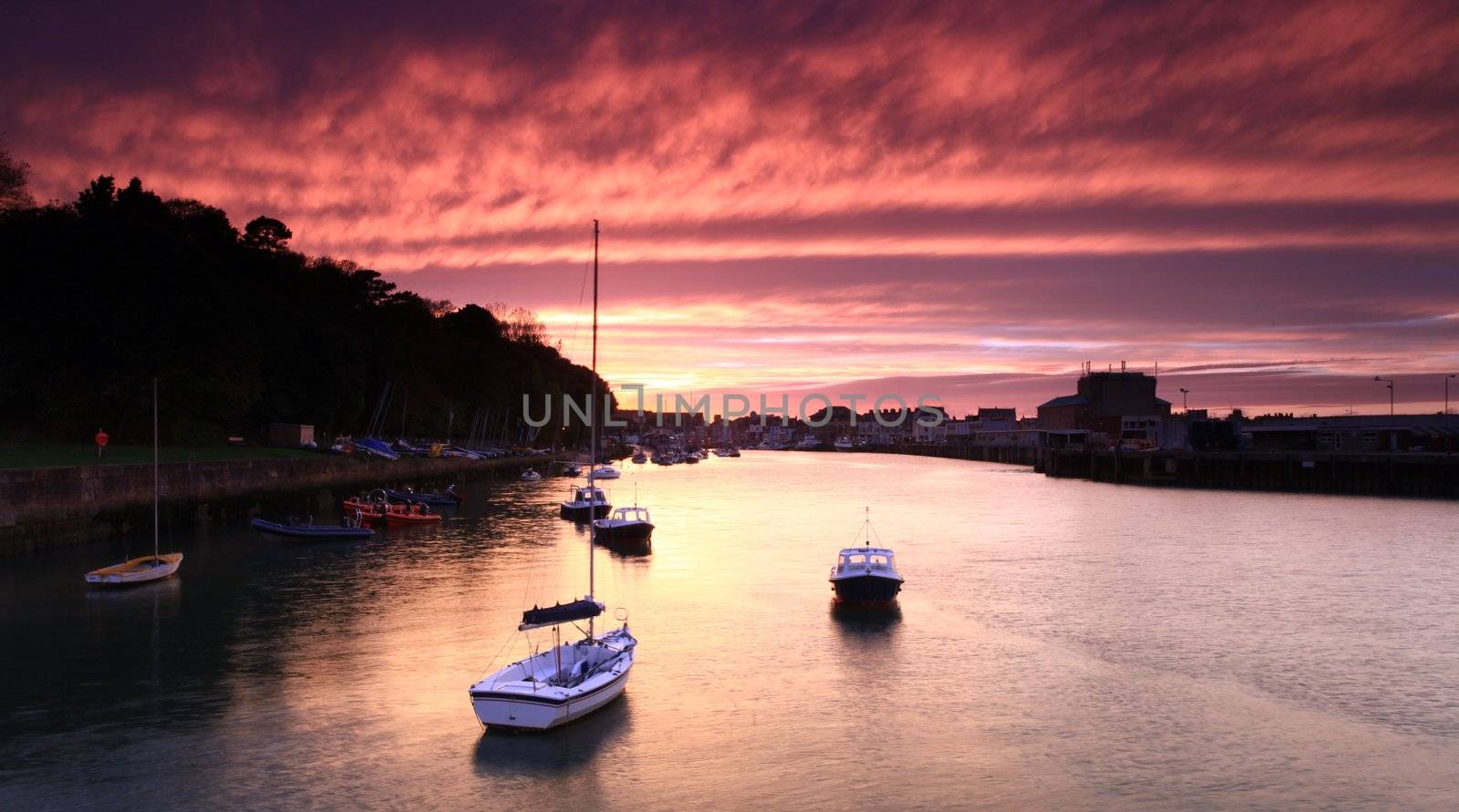 Entrance to weymouth harbour at dusk in southern england