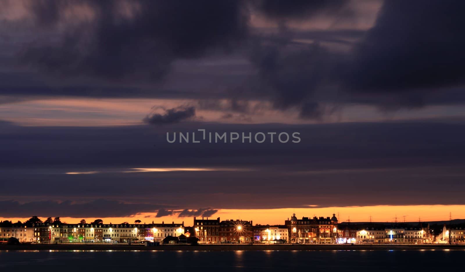 Night sets in  over Weymouth seafront taken from view over the sea