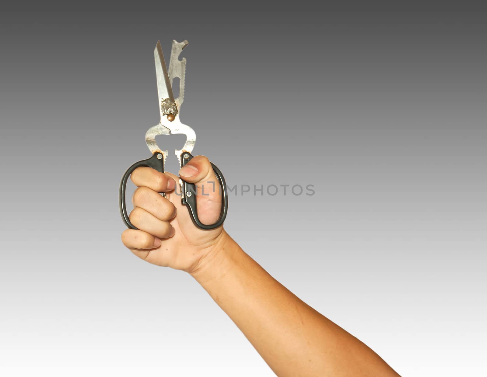 Hand holding a pair of scissors and ready to cut.