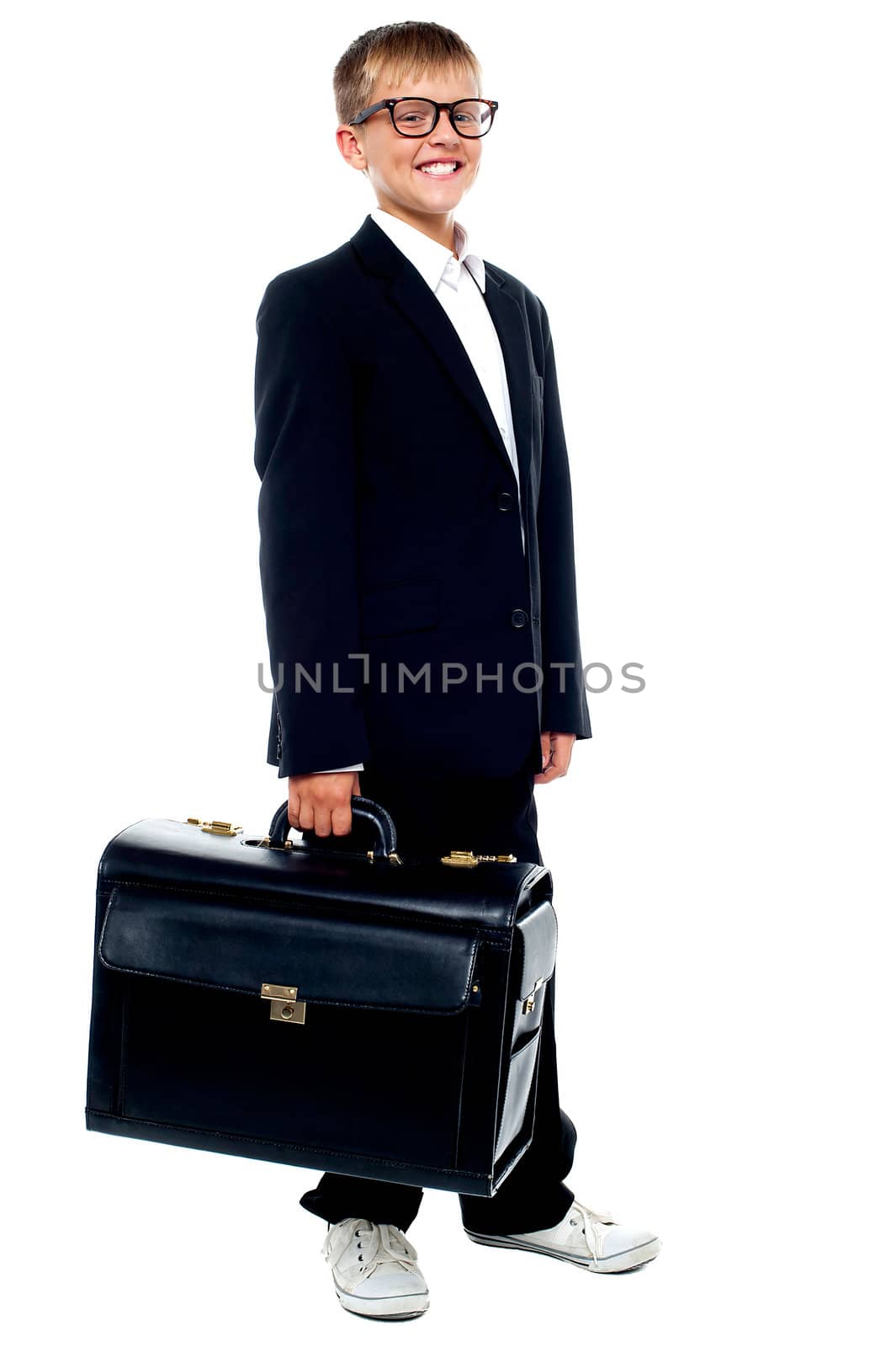 Full length portrait of cute boy carrying a briefcase isolated on white background