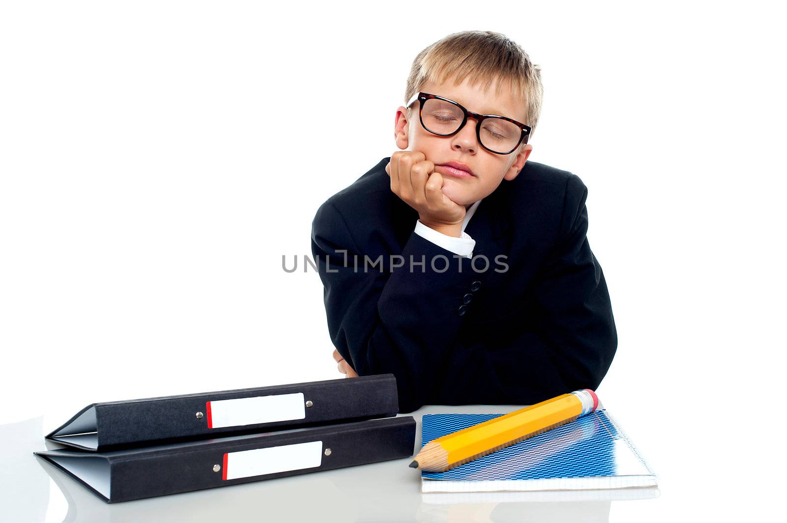 School boy in glasses dozing off during class