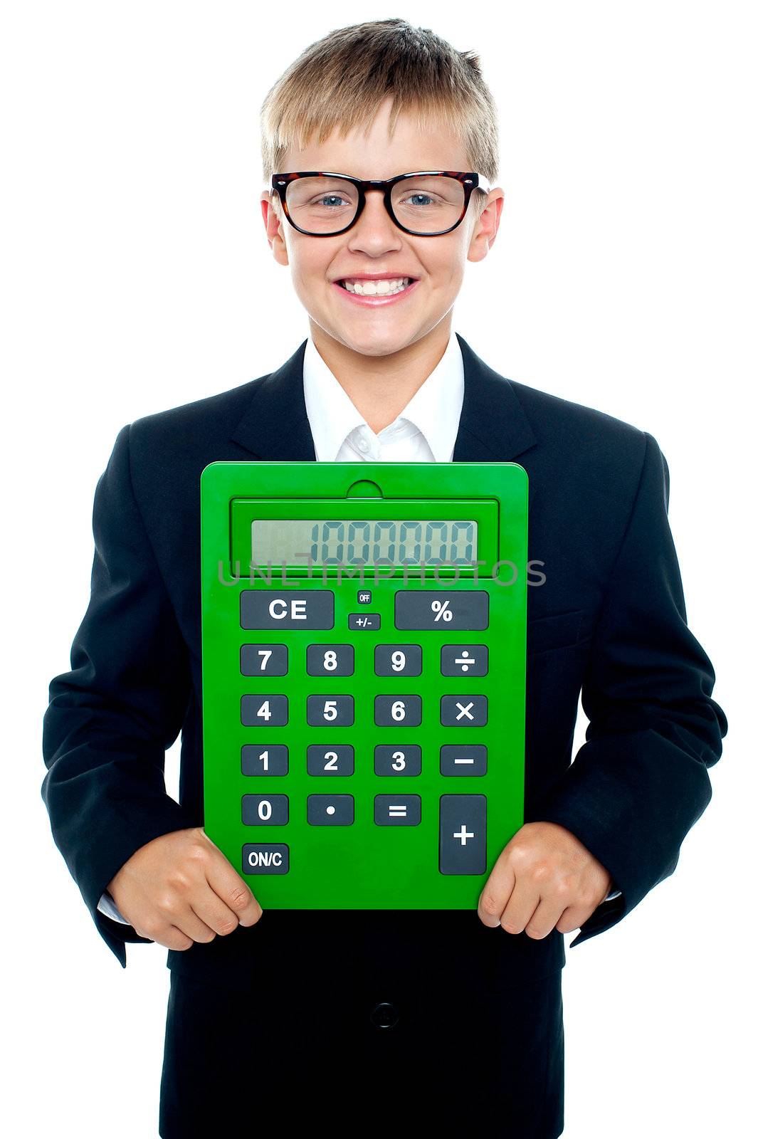 Bright young kid holding large green calculator displaying it to camera isolated on white