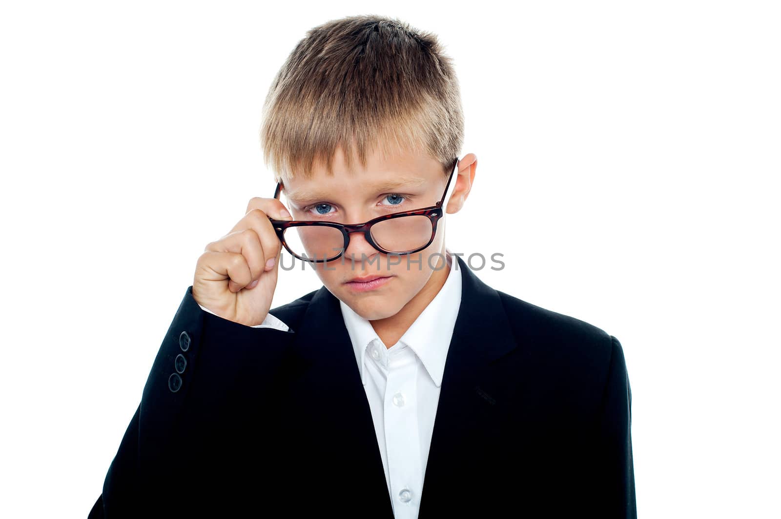 Cute little business boy looking through his eyeglasses isolated against white background