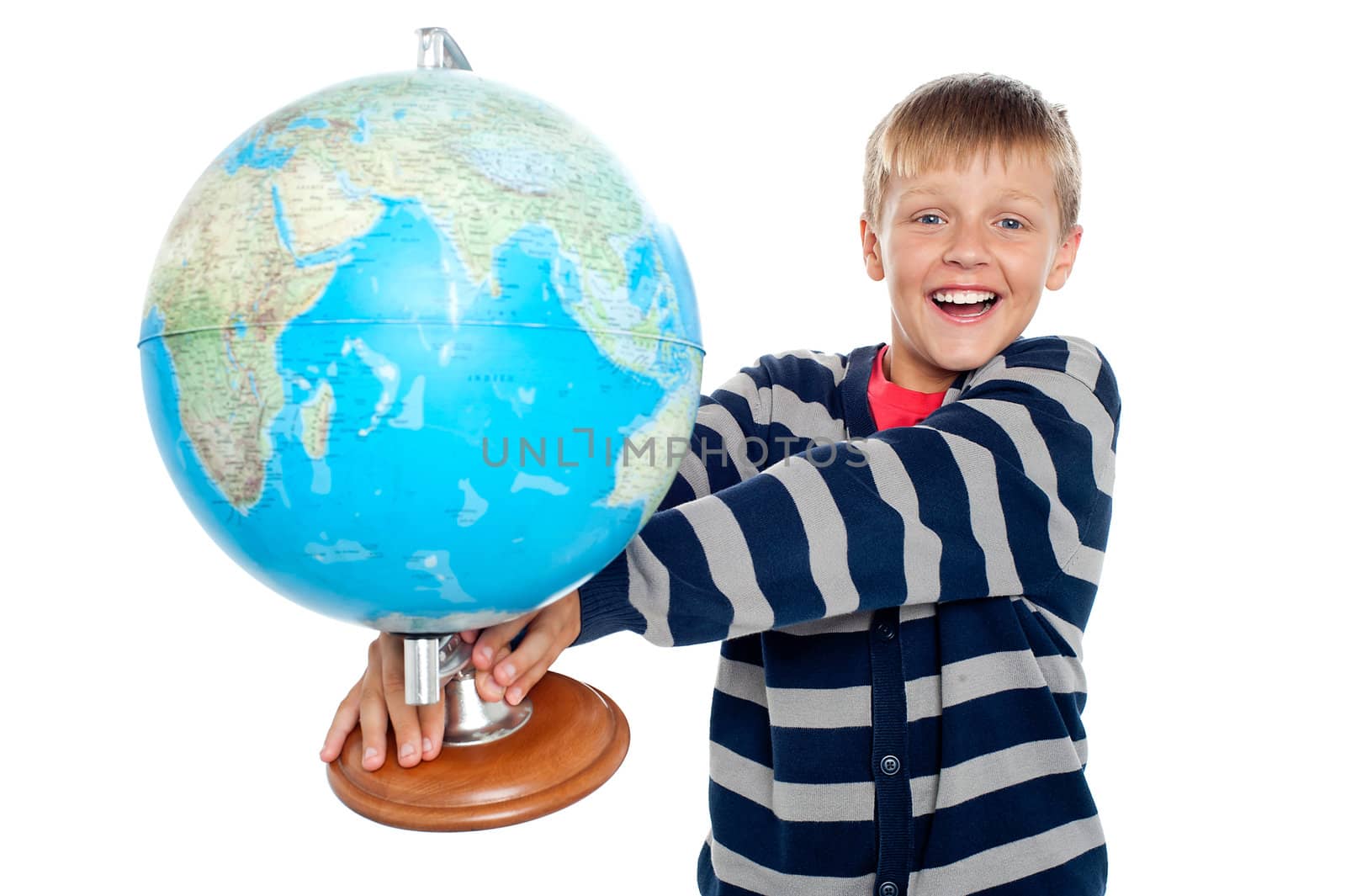 An excited school boy holding globe in his outstretched arms isolated against white background