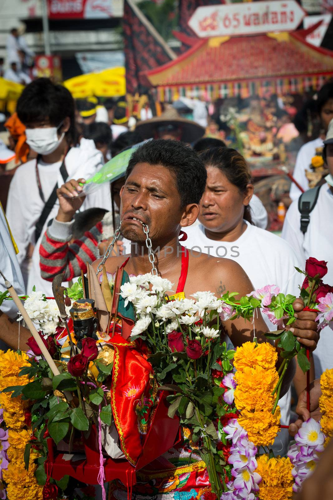 Phuket, Thailand - October 21, 2012: Devotee of Vegetarian Festival is Mah song, person who invites the spirits of gods to possess their bodies.  Mah song wearing elaborate costumes and pierce their cheeks and tongues with all manner of things.