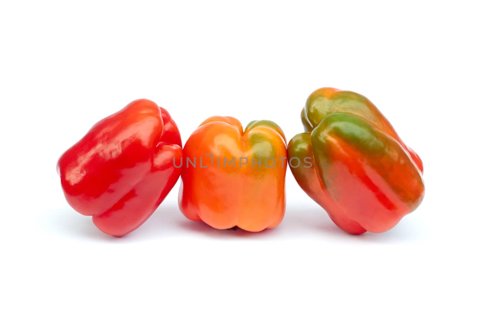 Three sweet peppers on white by qiiip