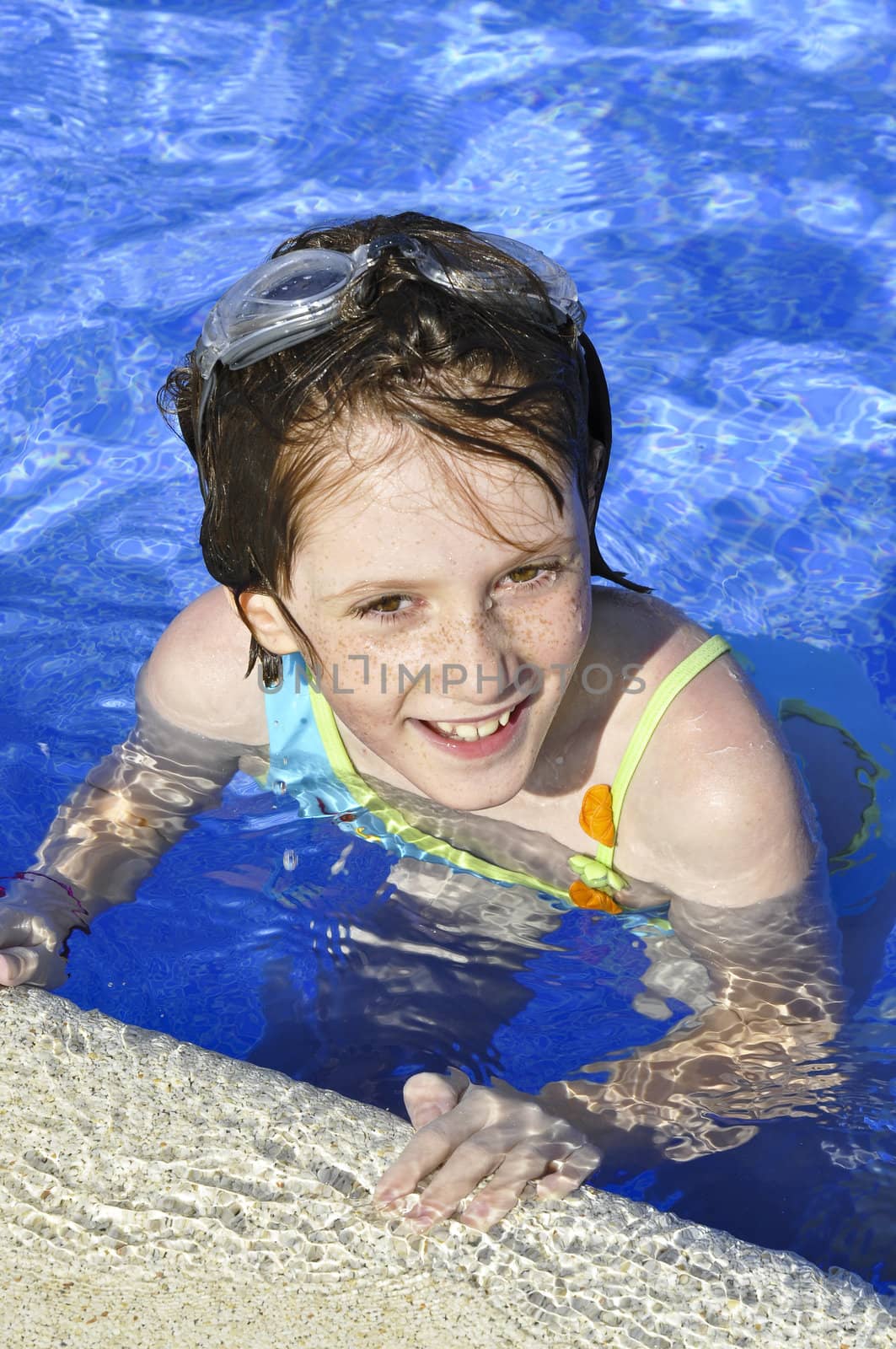 girl smiling and happy in the pool in summer