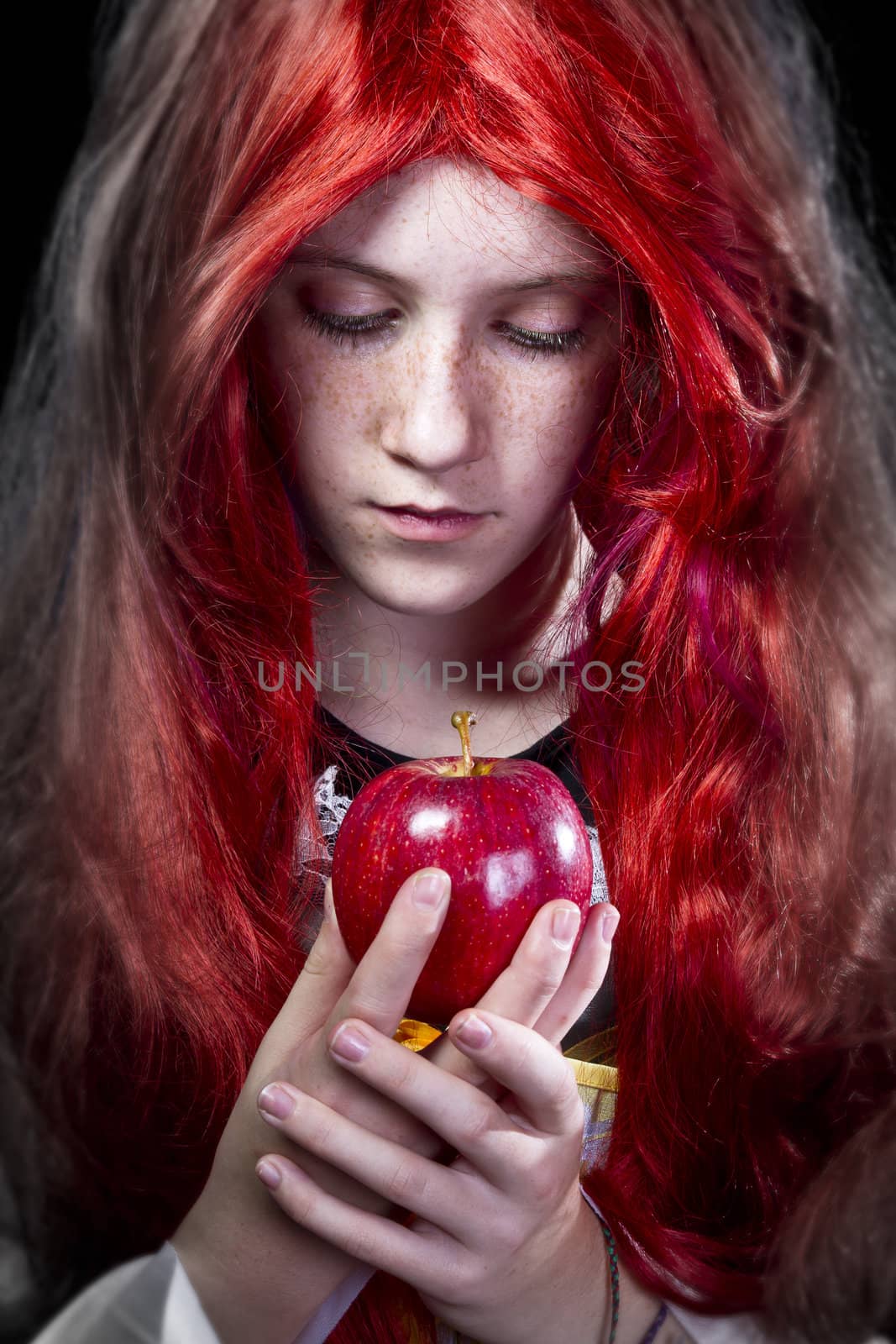 Girl with red apple in a poetic representation