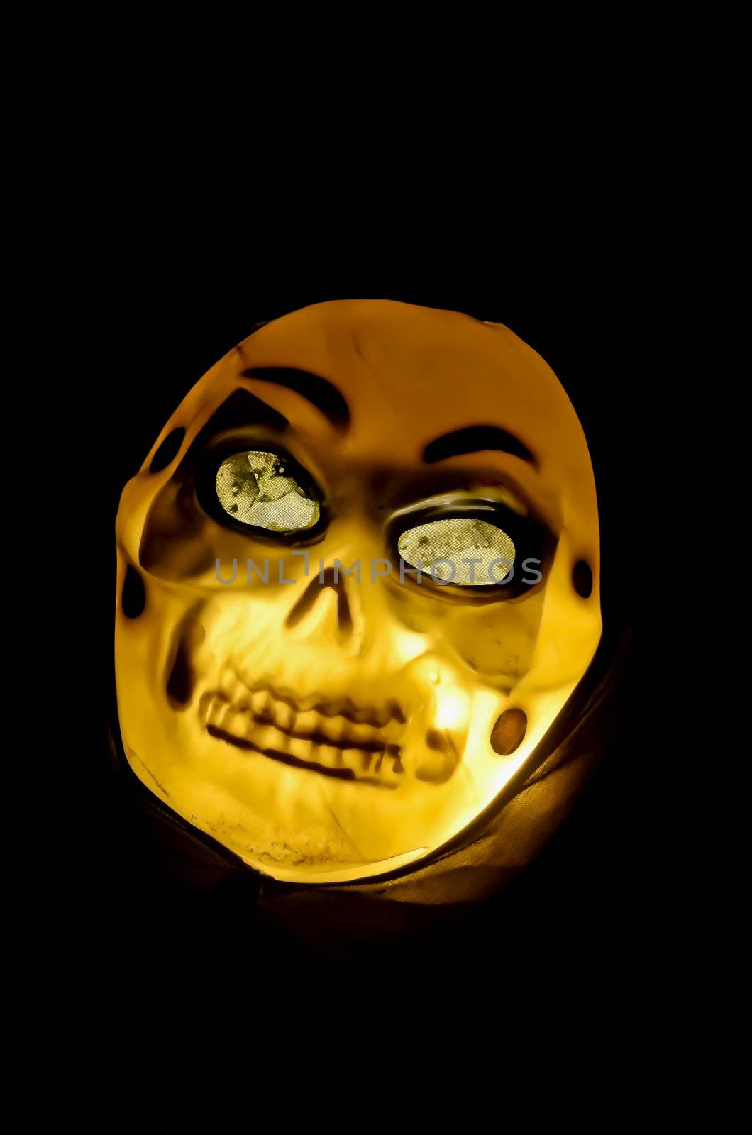 Halloween skeleton mask shot against black background