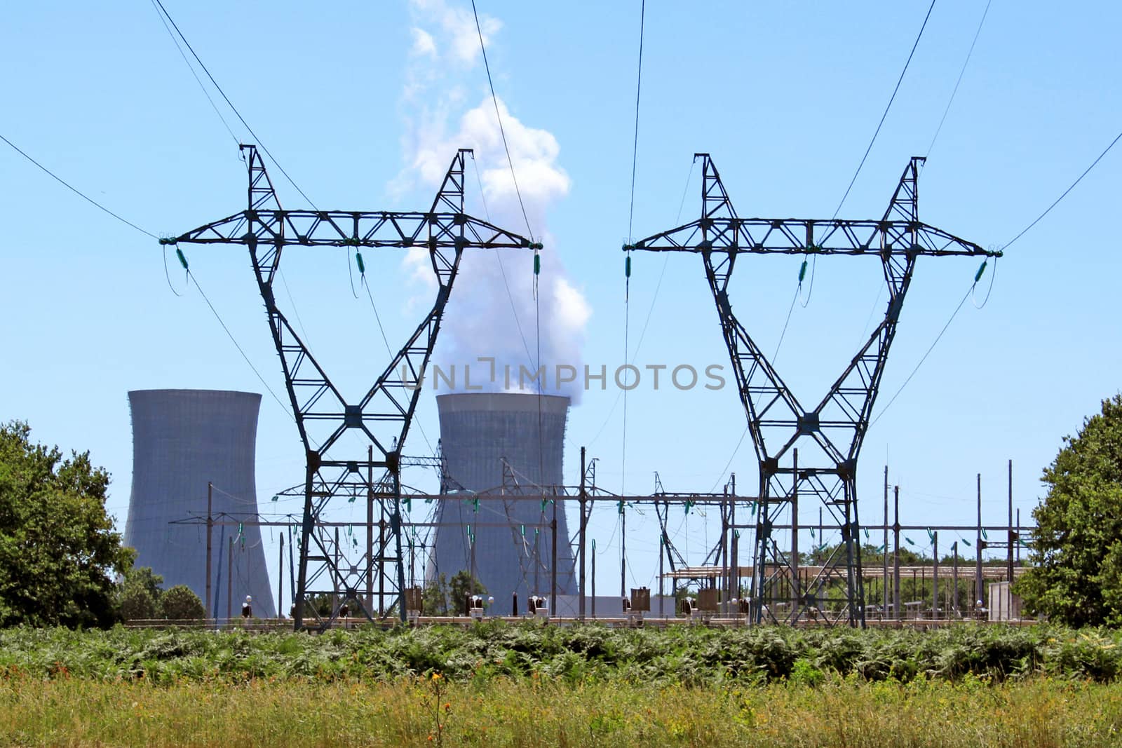 electric pylons in front of a nuclear power plant