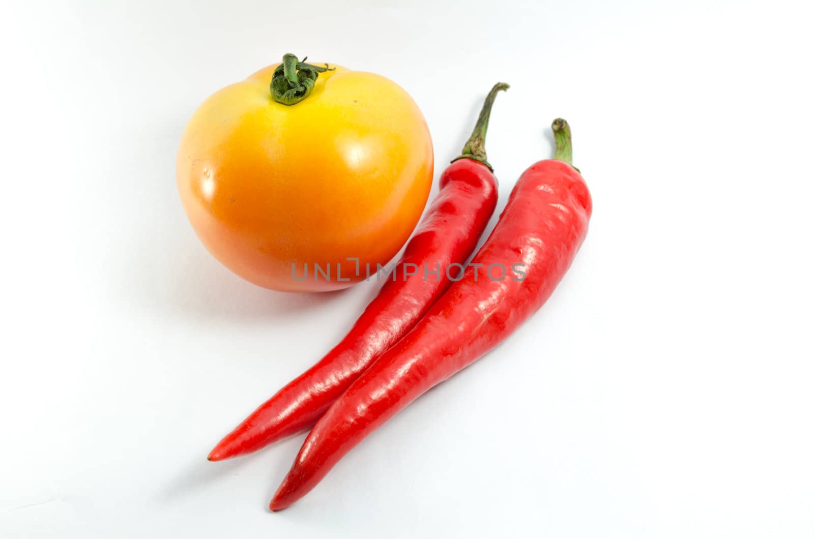 Tomato and chili isolated on white