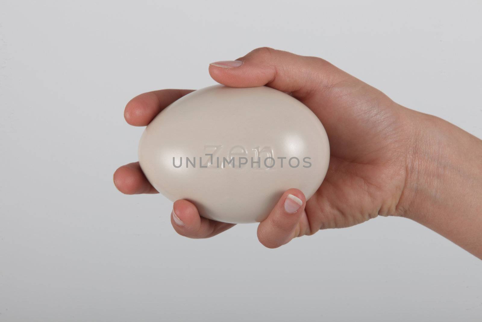 Hand holding pebble by phovoir