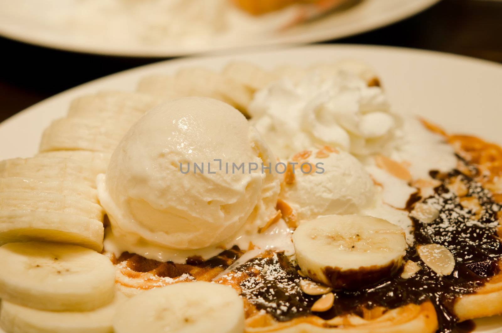 vanilla ice cream waffle with bananas and whipping cream