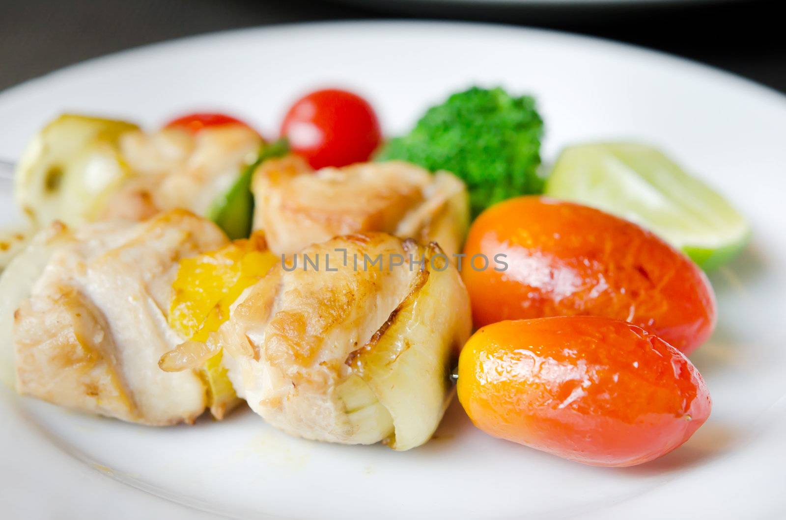 Grilled pork with  onion , peppers , tomato and fresh vegetable
