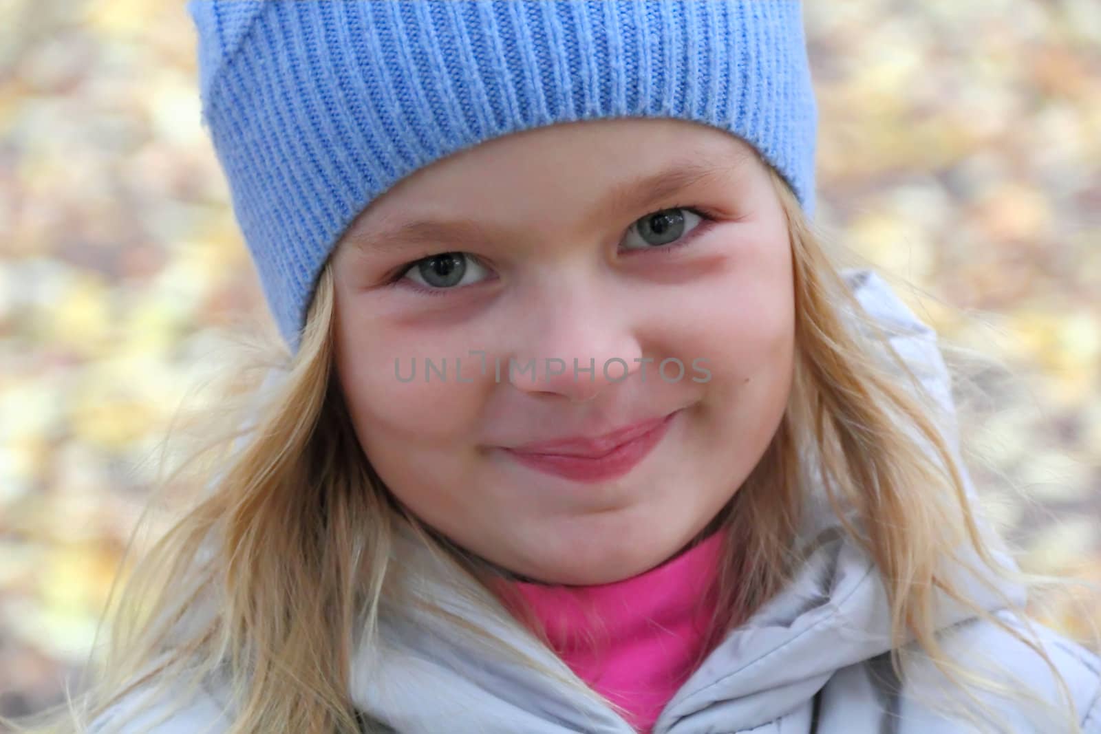 Portrait of beautiful girl with blond hair and blue eyes