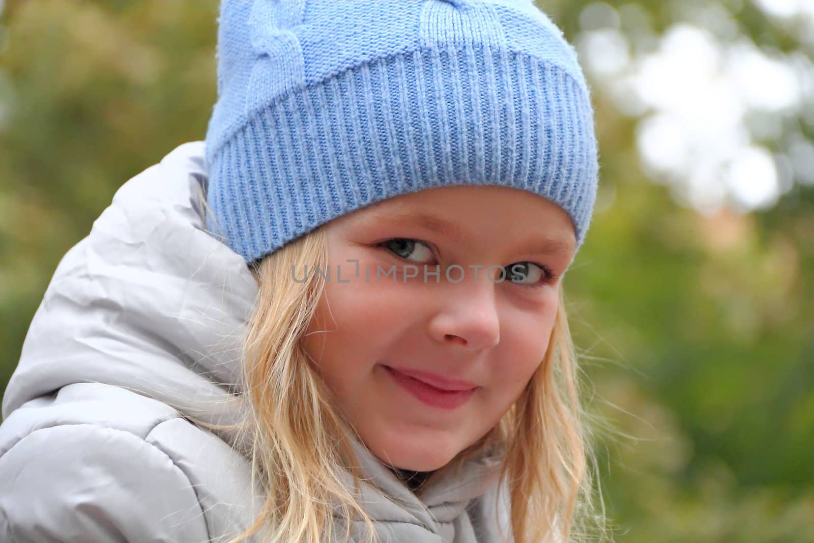 Portrait of beautiful girl with blond hair and blue eyes