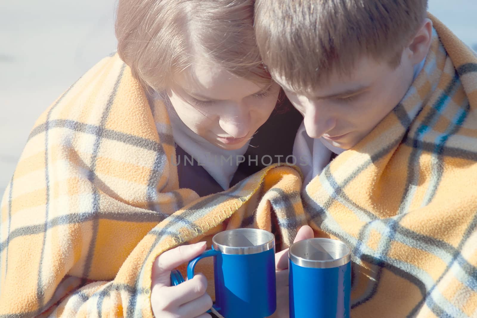 Young couple embracing in winter  drink tea by victosha