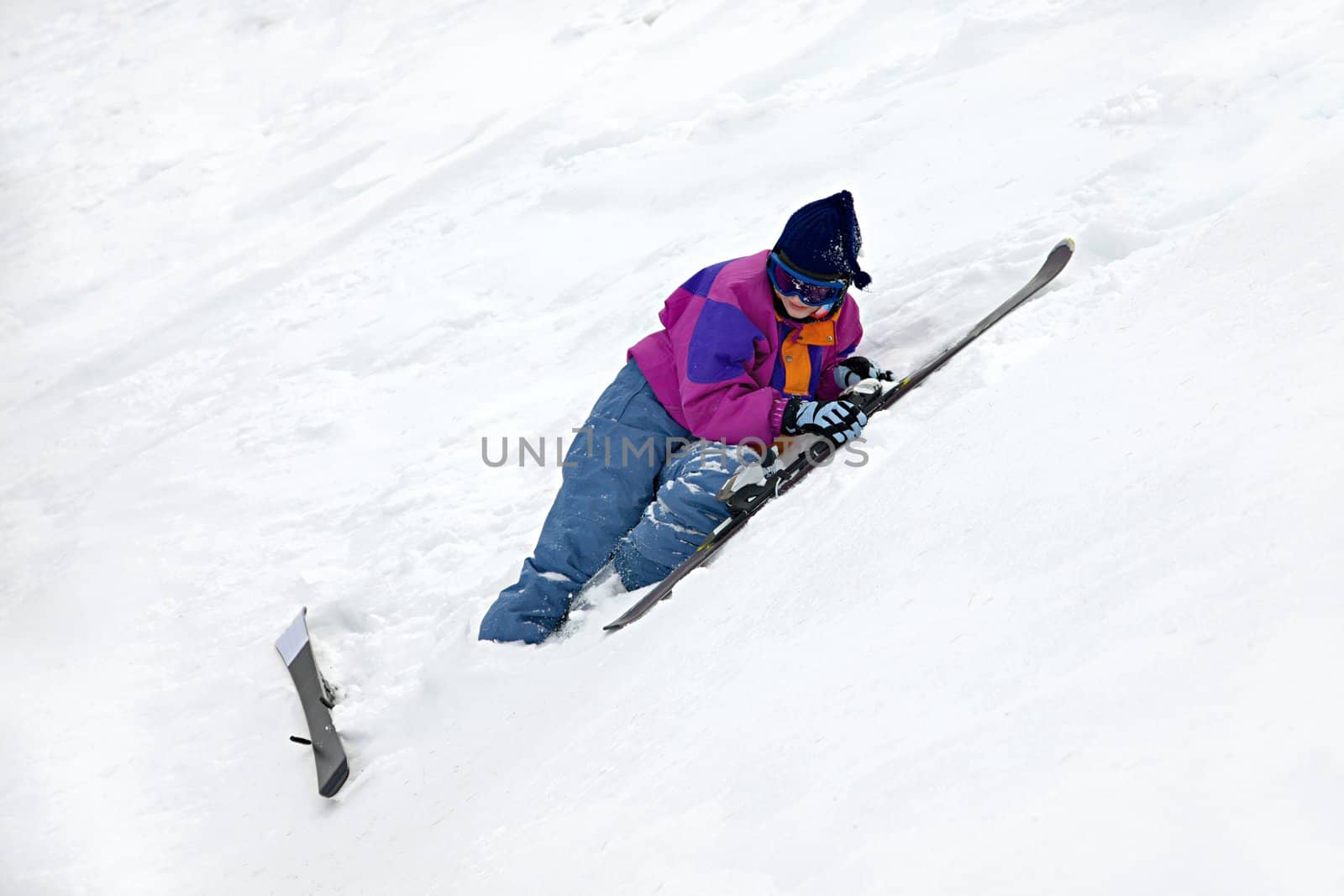 Beginner skier falling on the snow