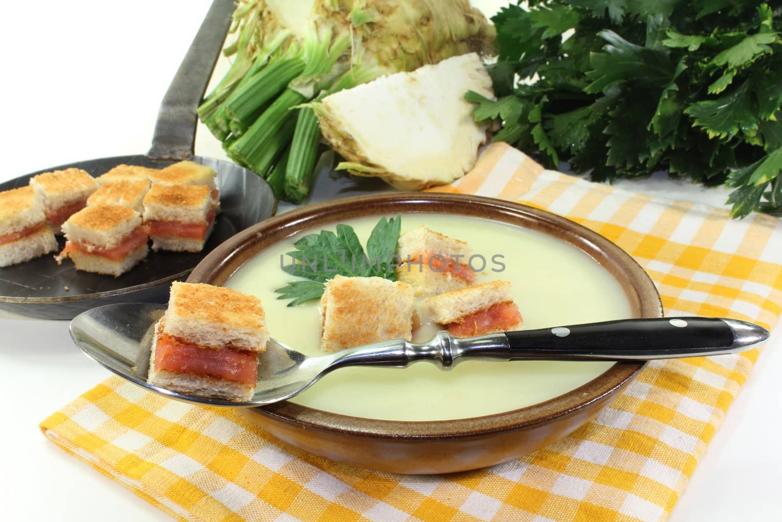 a bowl of Cream of celery soup with salmon croutons