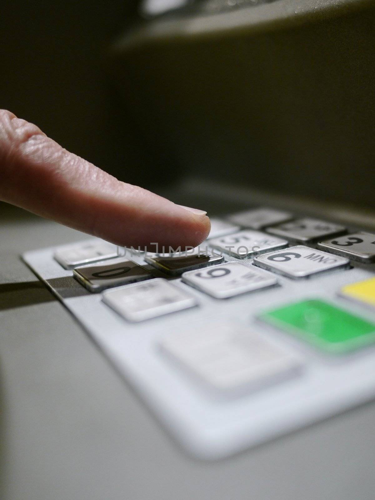 Finger using automatic teller keypad to enter pin number
