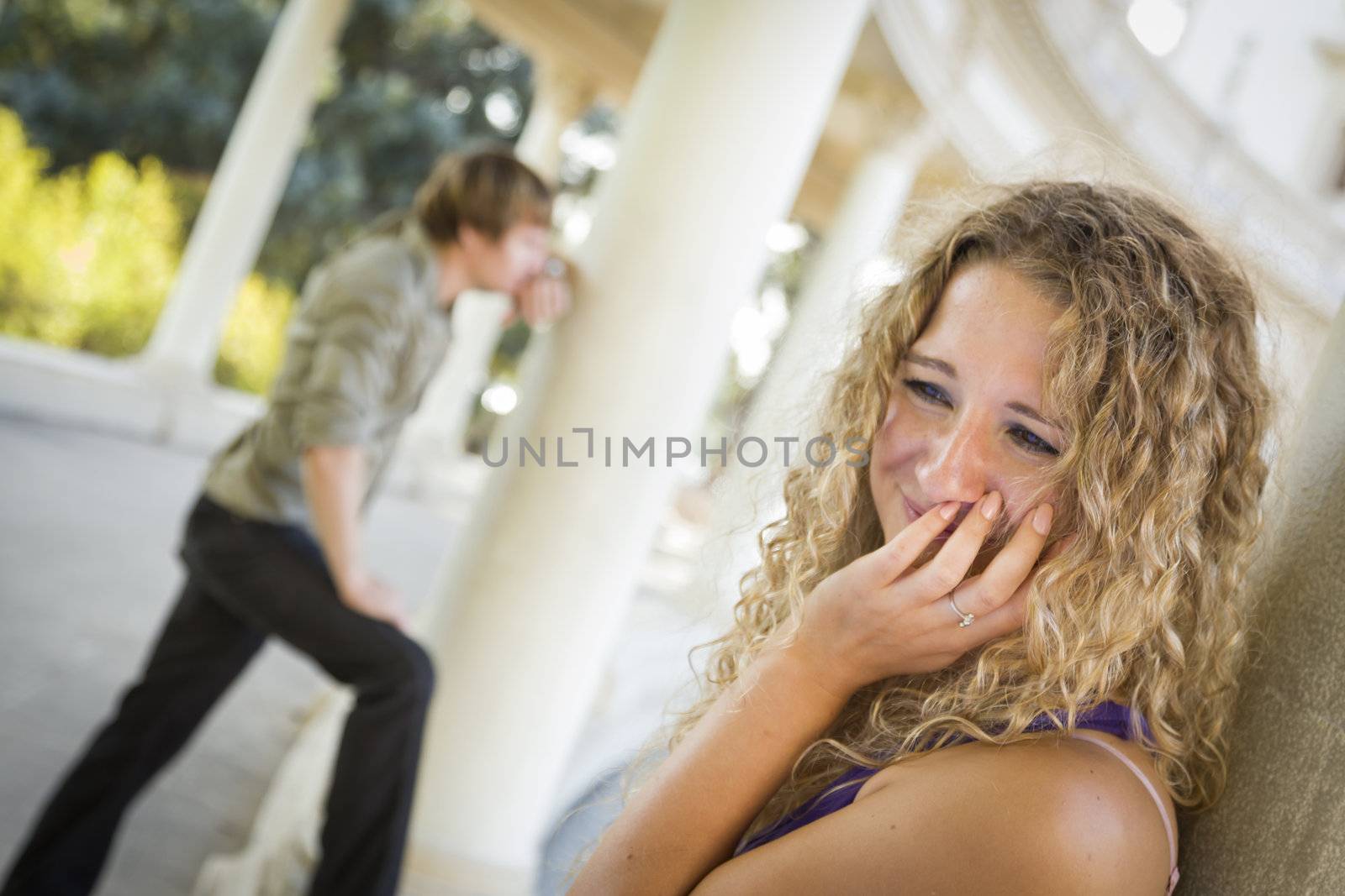 Woman Upset in the Foreground While Man Comtemplates in the Background