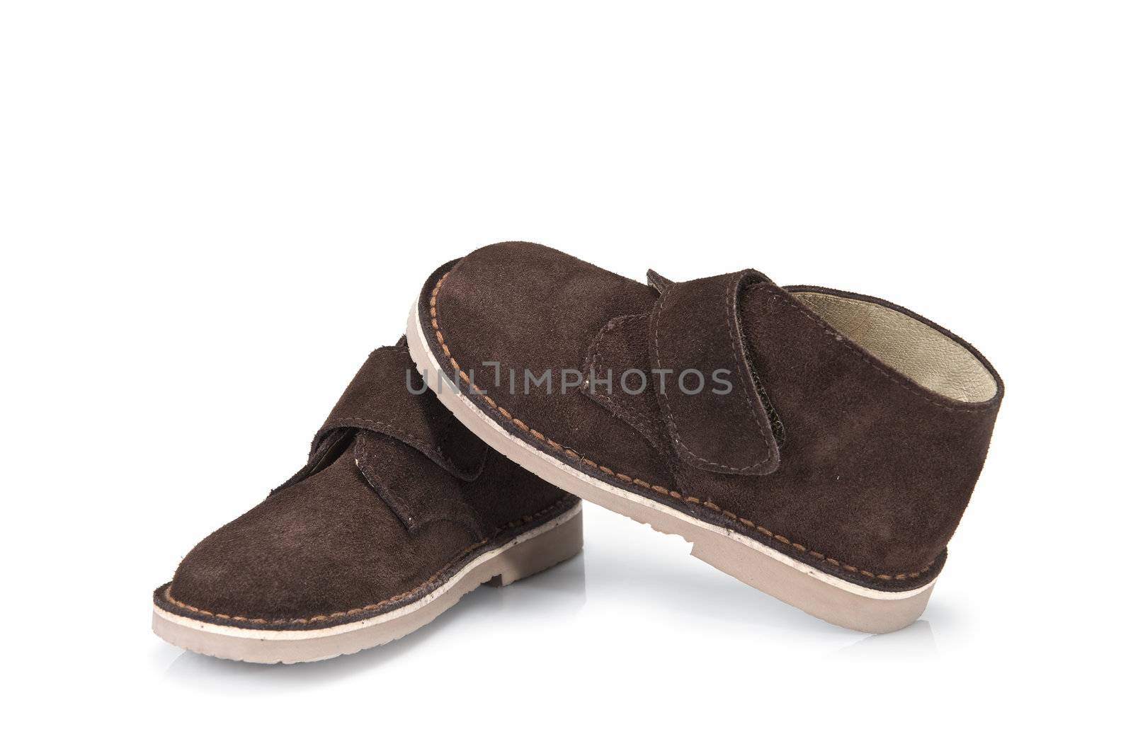 Brown leather boots for kids isolated on a white background.