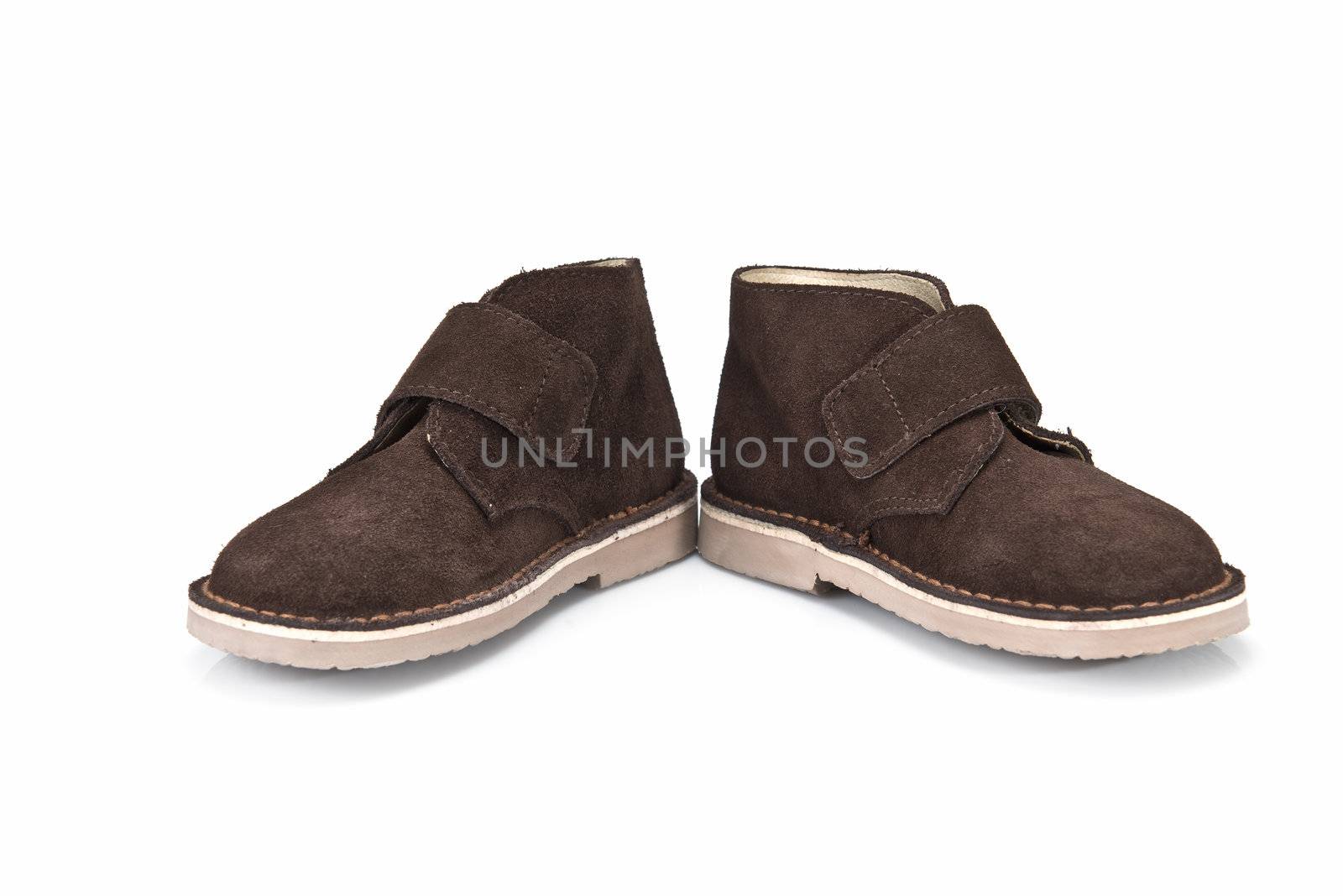 Brown leather boots for kids isolated on a white background.