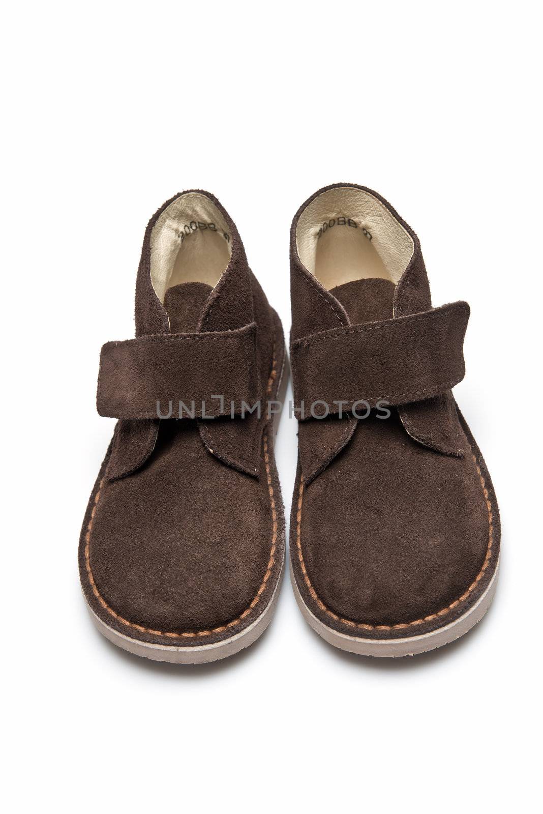 Brown leather boots for kids isolated on a white background.