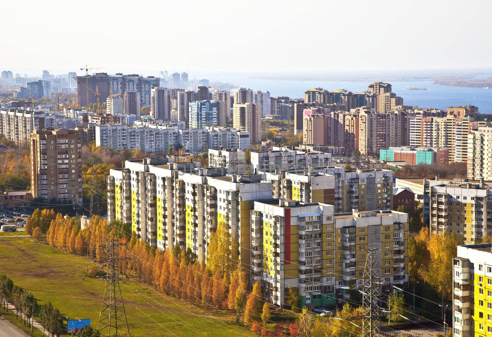 Sleeping area of social housing in the city of Samara. Against the background of the Volga and the houses under construction in the city center. The urban landscape.
