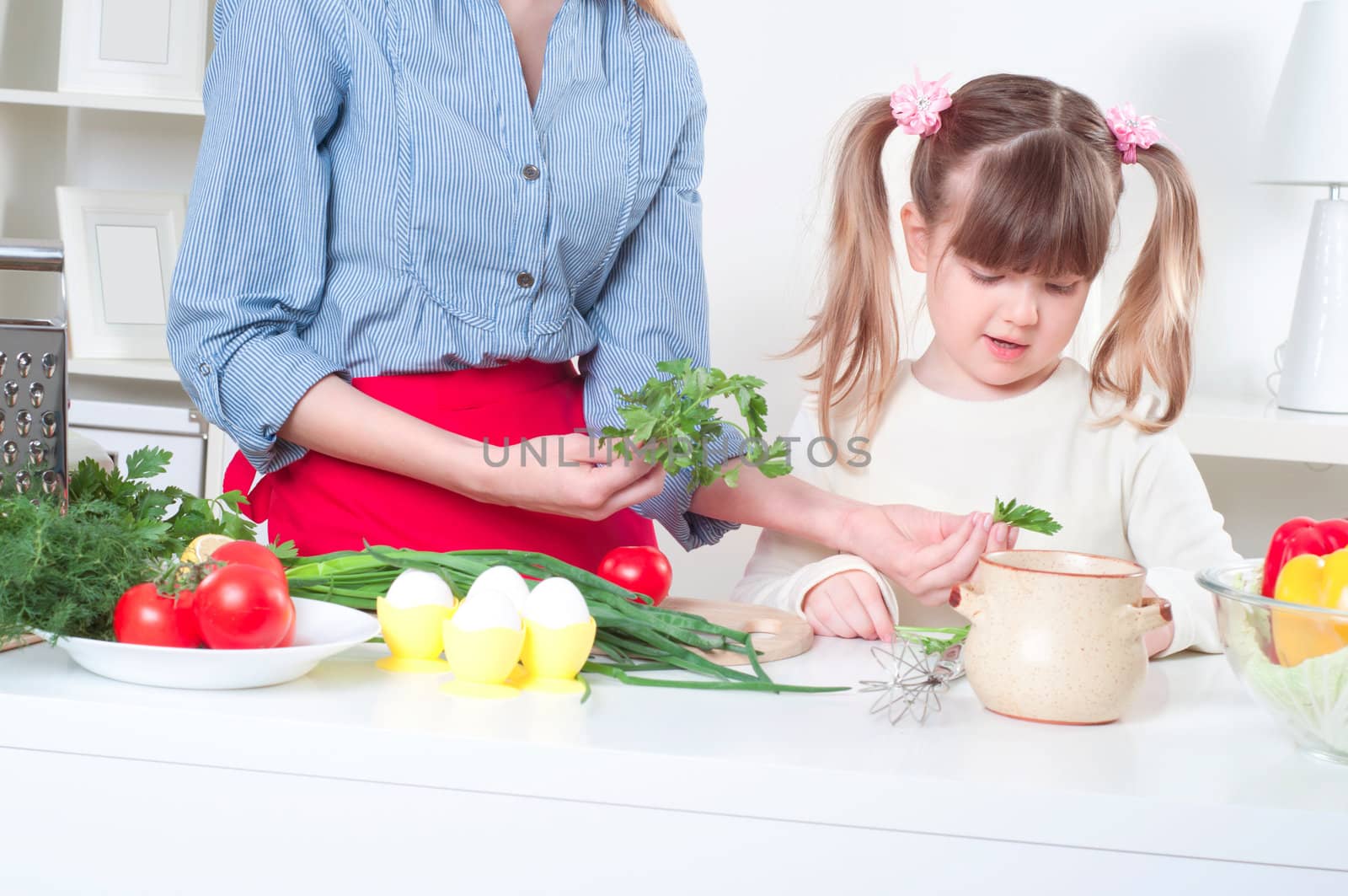 Mother and daughter cooking together, help children to parents