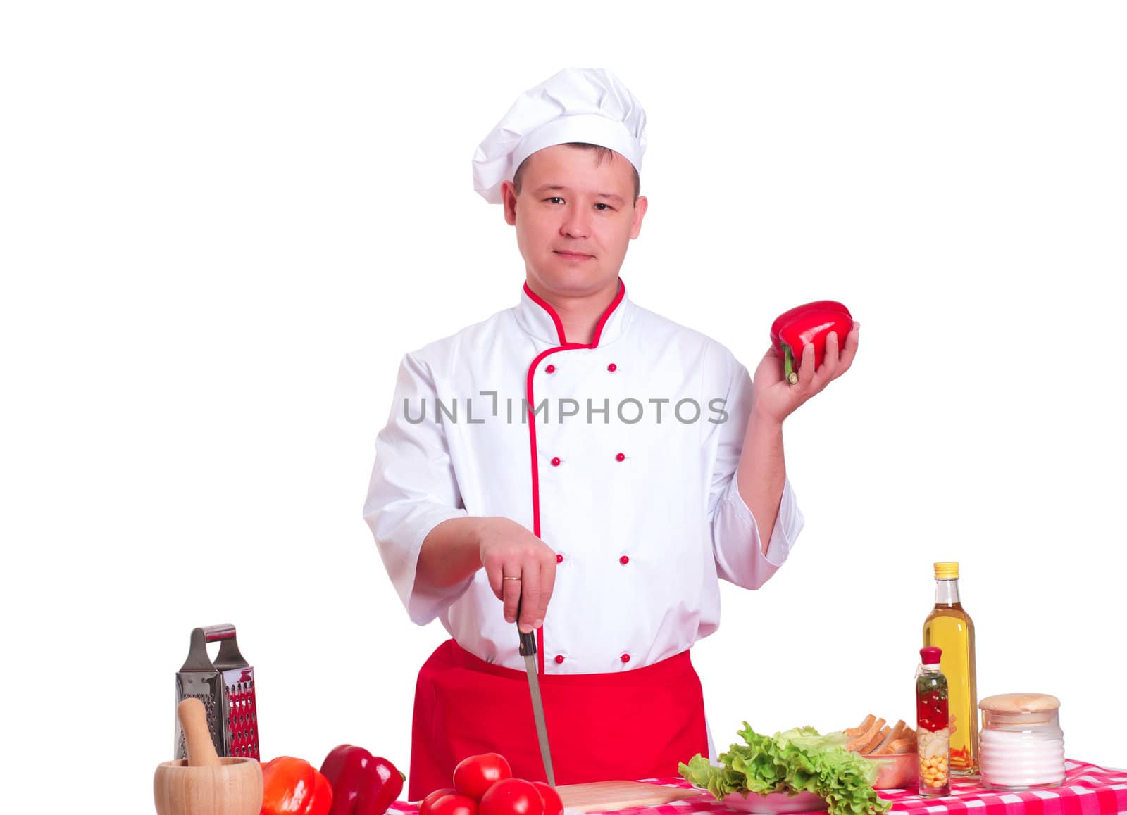 Handsome man cooking in the kitchen at home by adam121