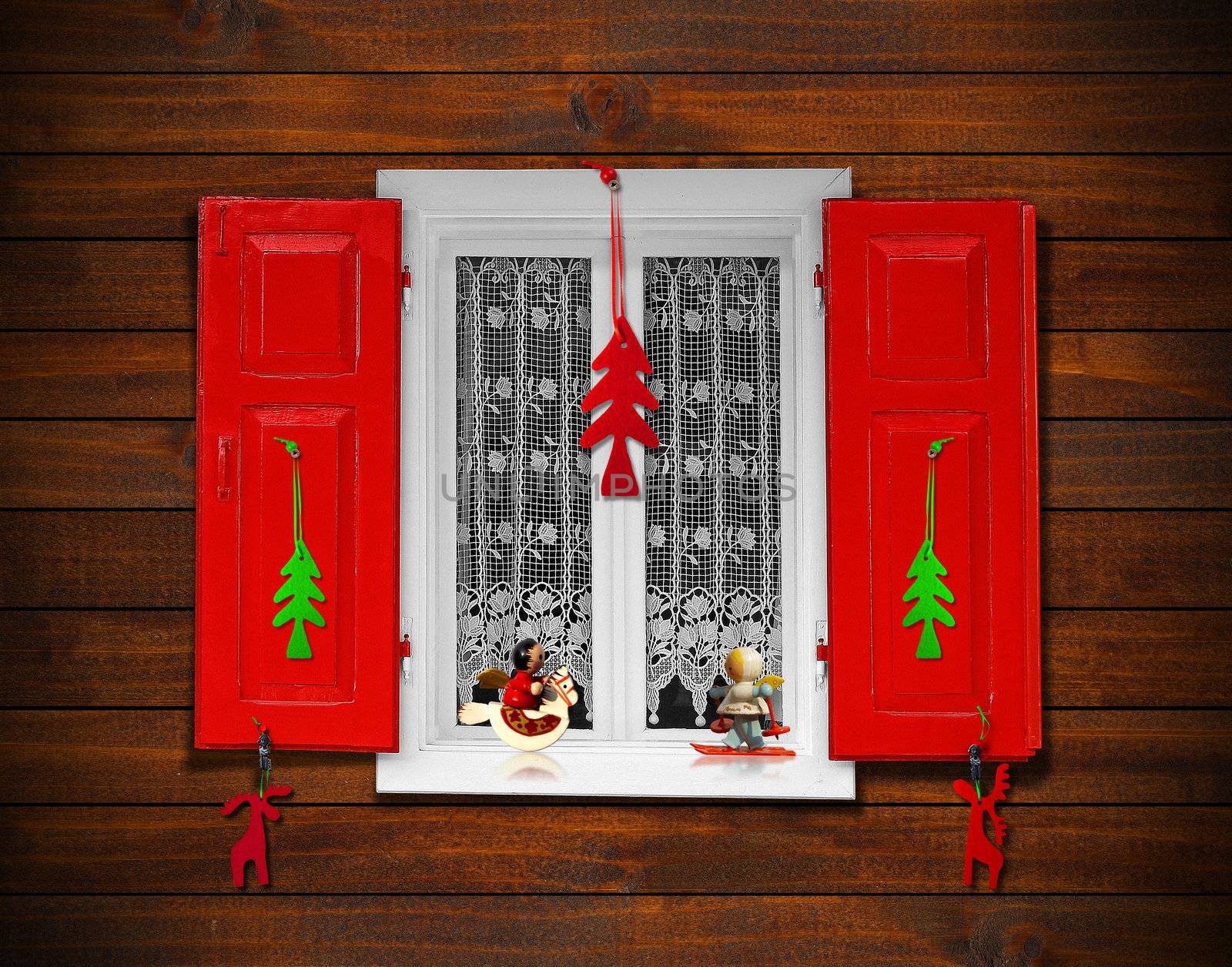 Window with red shutters and Christmas decorations on wooden wall
