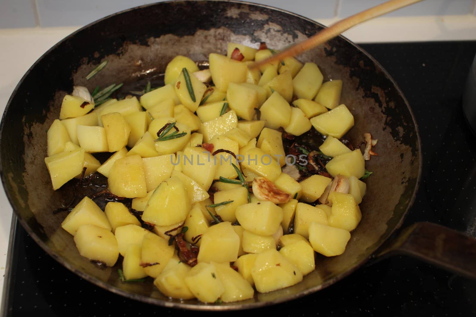 Close-up of sauteed potatoes in a griddle pan