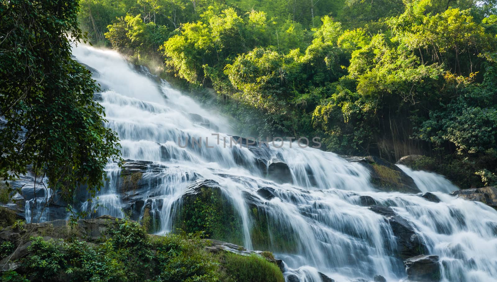 close up maeya water fall of chiangmai thailand with sun light