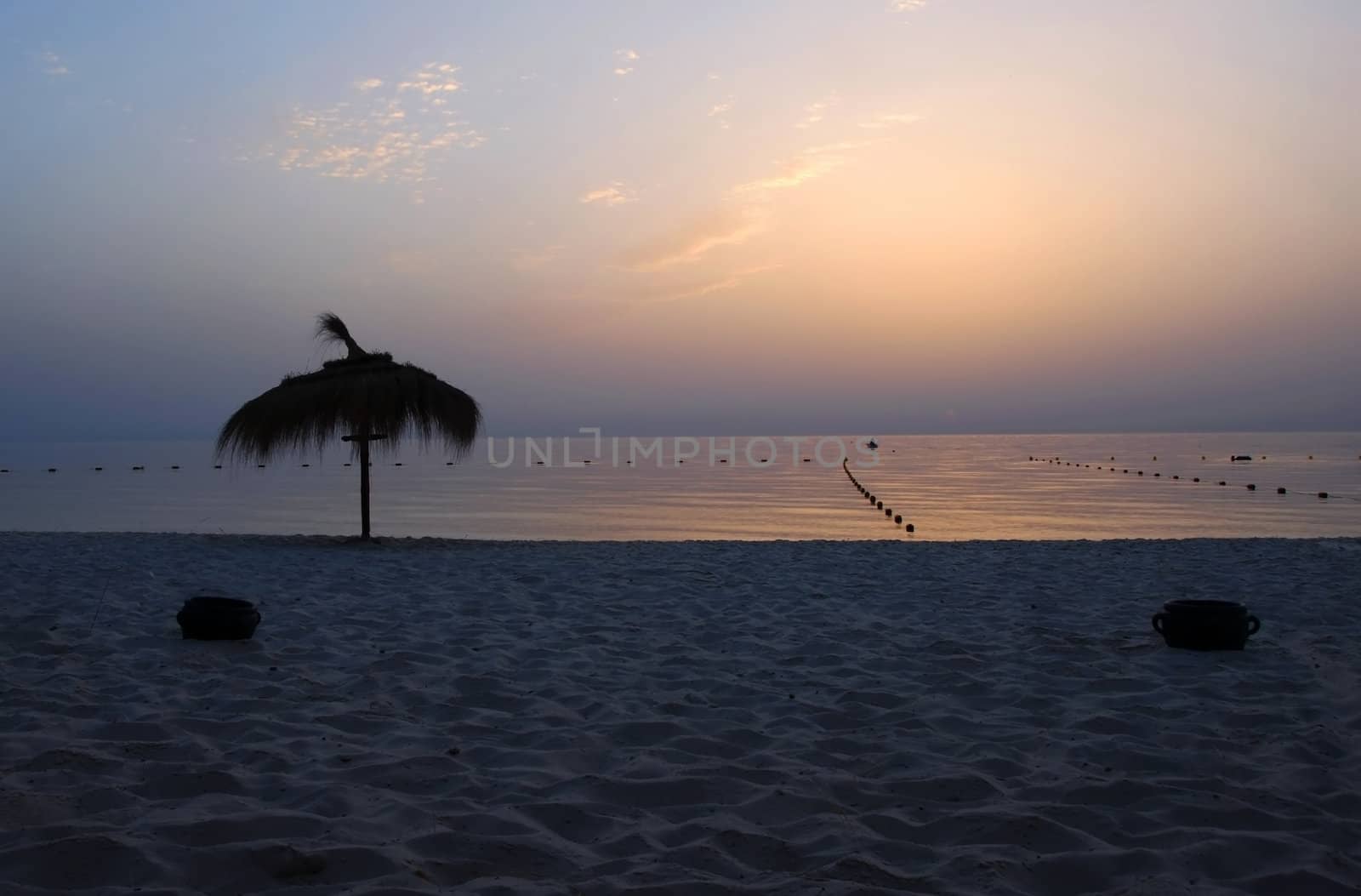 gorgeous sunrise over tranquil sea water on beach in Tunisia