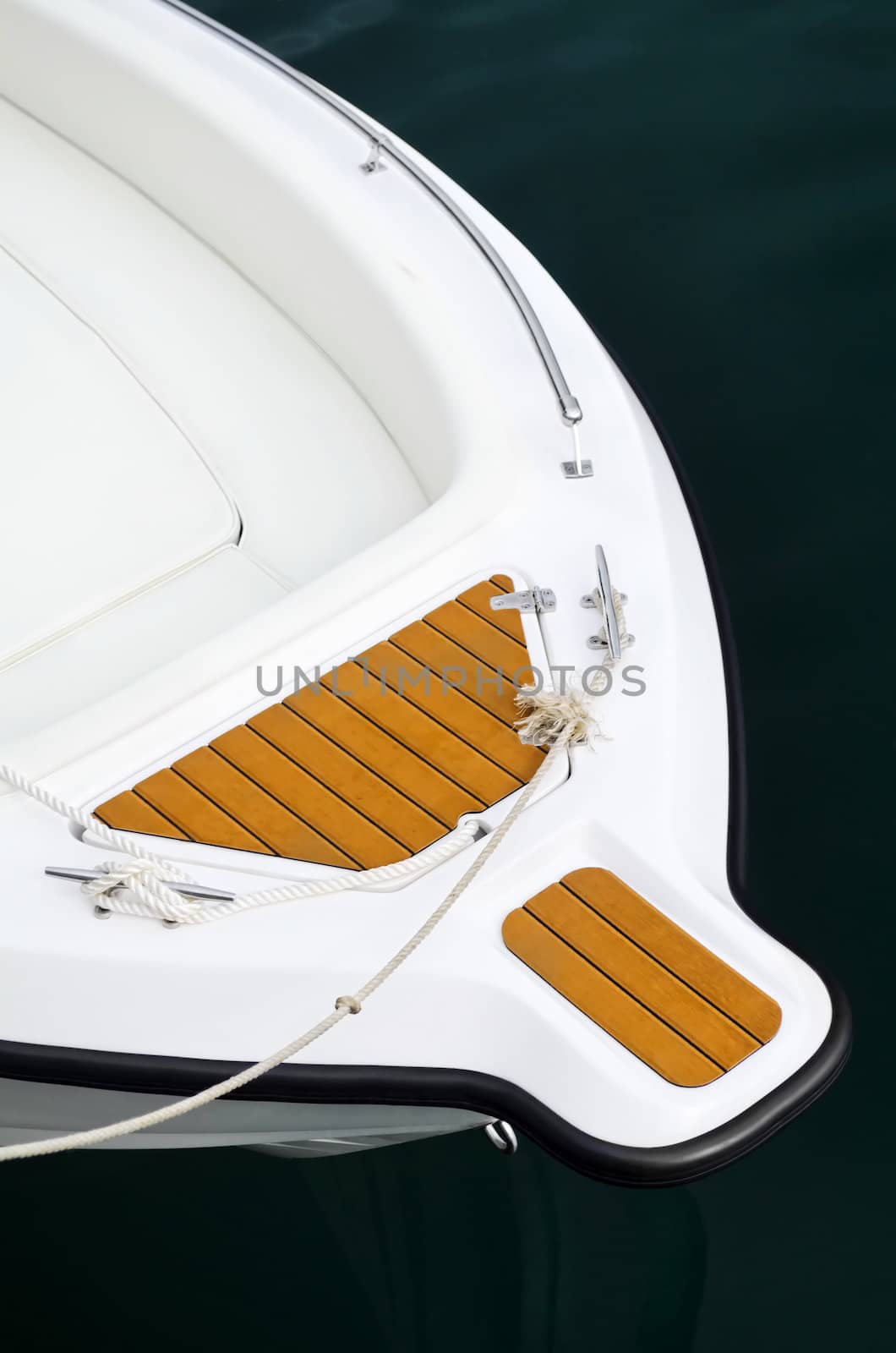 Top shot of bow of white speed boat on water