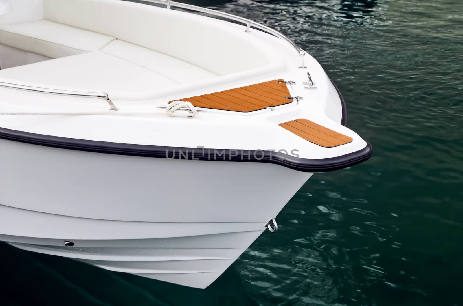 Close-up shot of bow of white speed boat on water