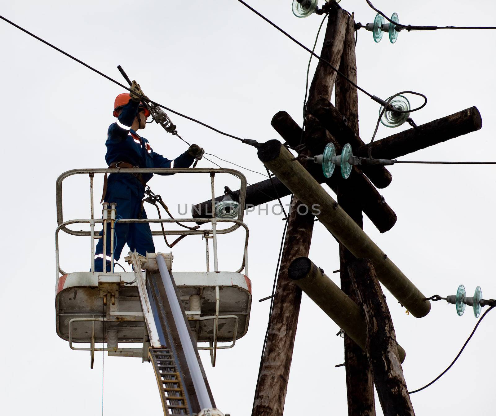 Electrician working at height by AleksandrN