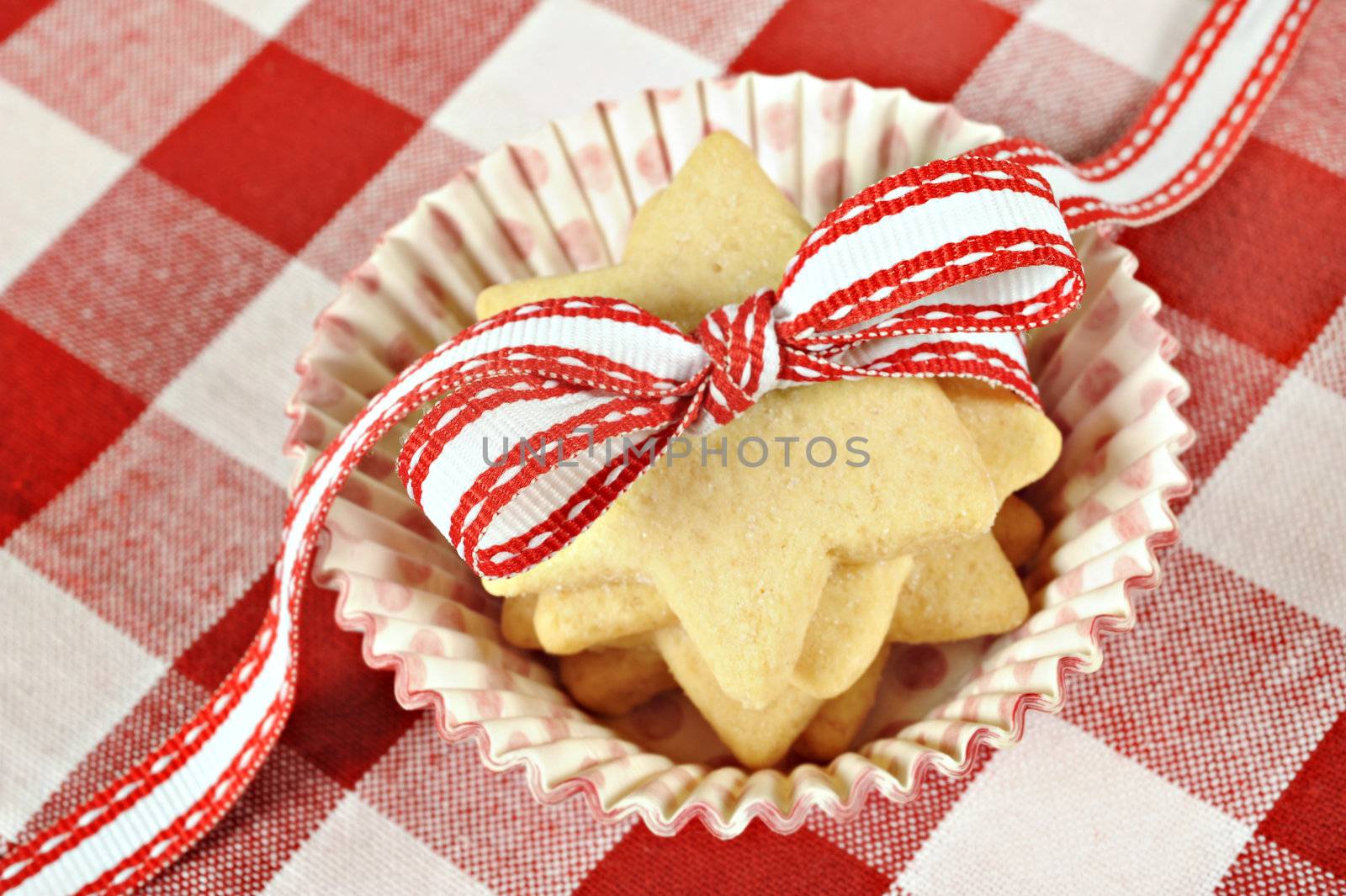 Star cookies with ribbon on  checkered cloth by tish1