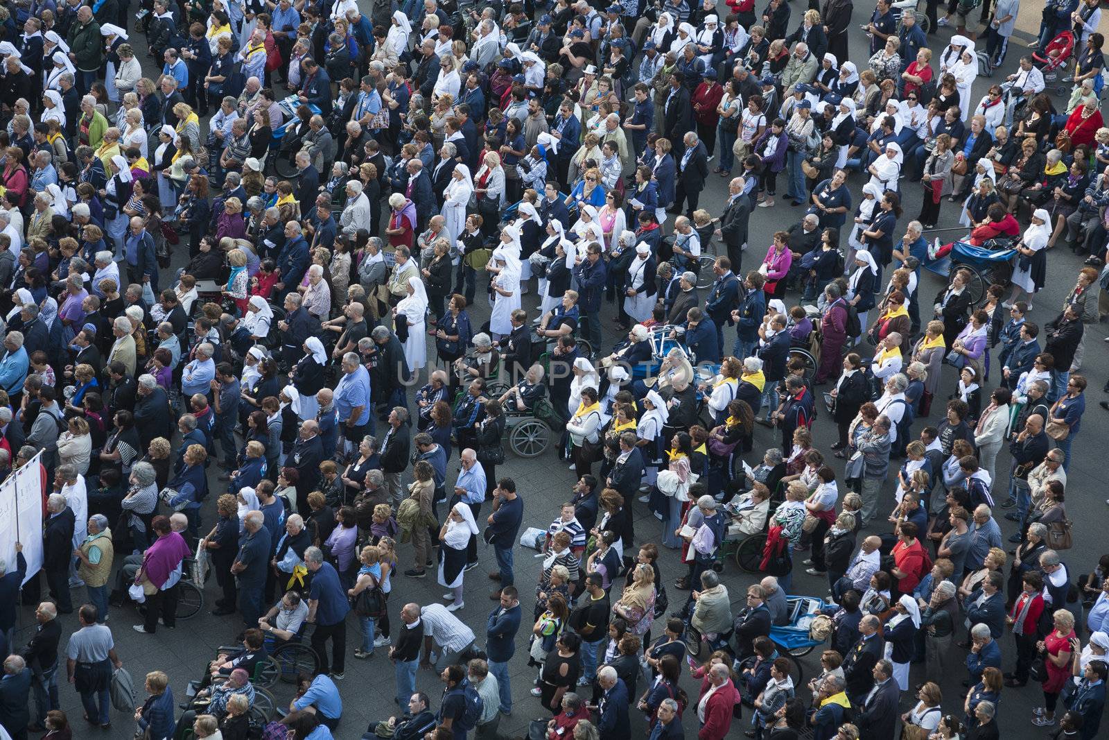 LOURDES, FRANCE - SEPTEMBER 24: Pilgrims from all over the world gathered to outdoor mass at Lourdes shrine on September 24, 2012. Among them a lot of disabled people hoping for cure or a miracle.