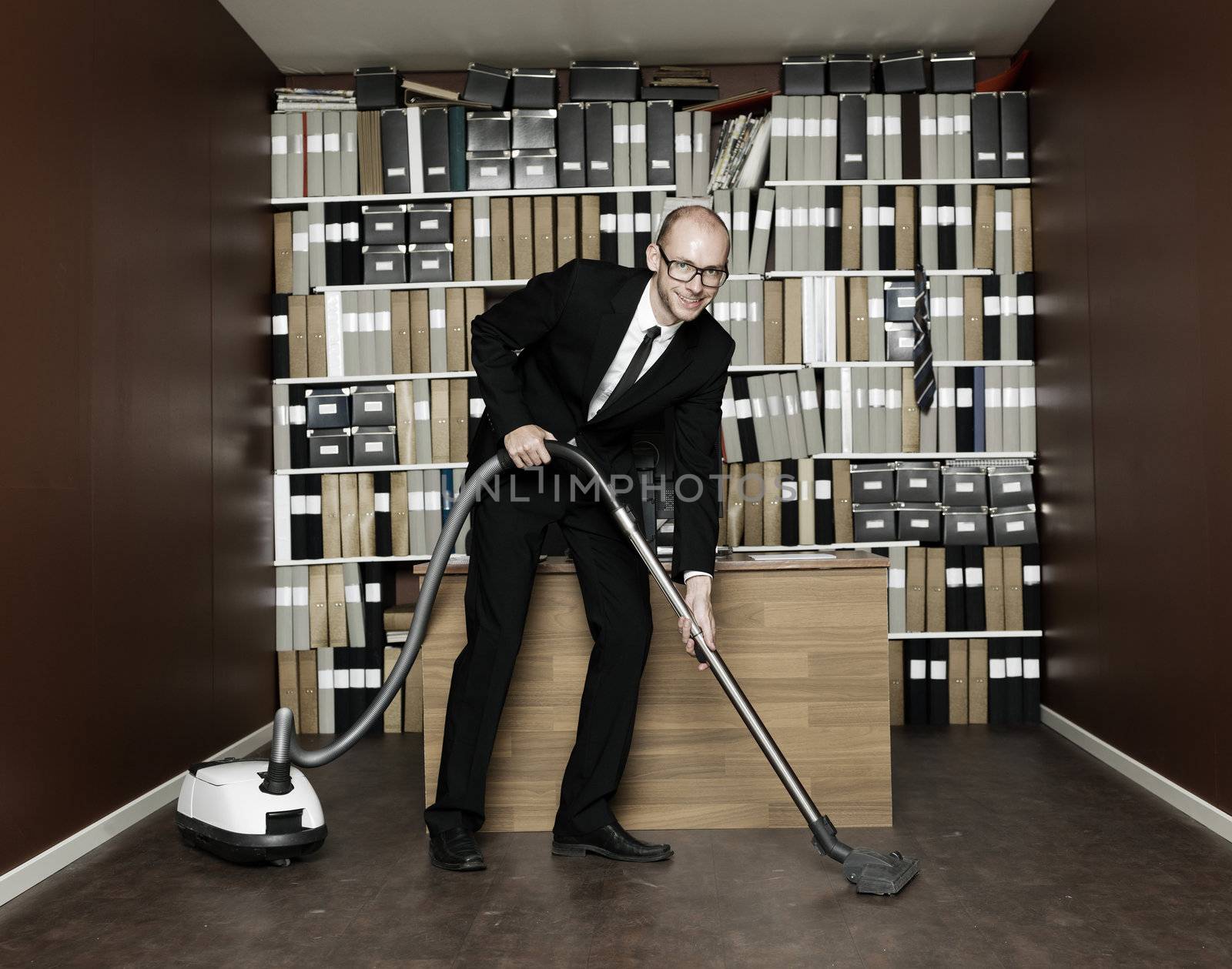Happy Businessman cleaning the office