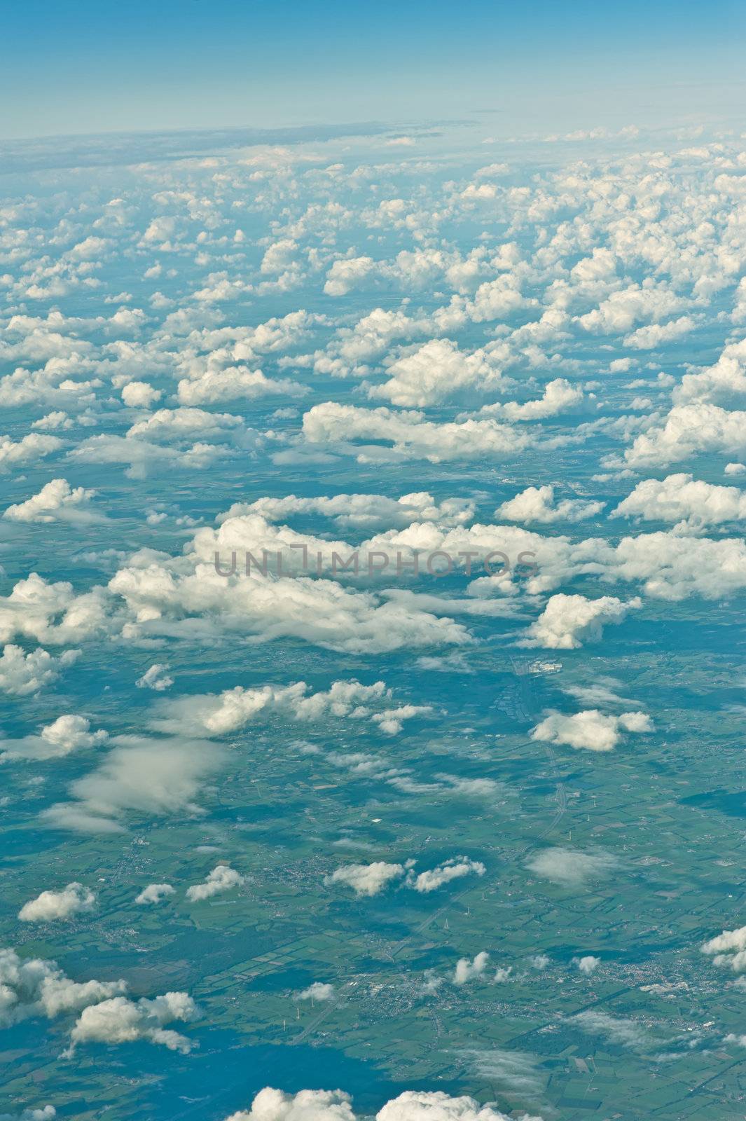 View over the clouds out of an airplane by 3523Studio