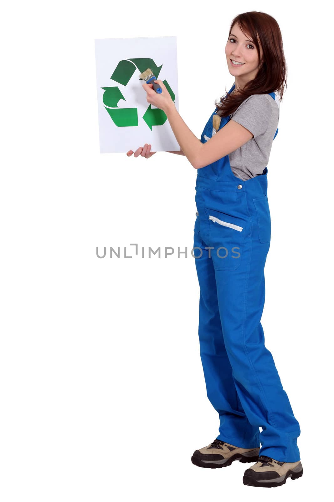 A female manual worker holding a recycle sign.