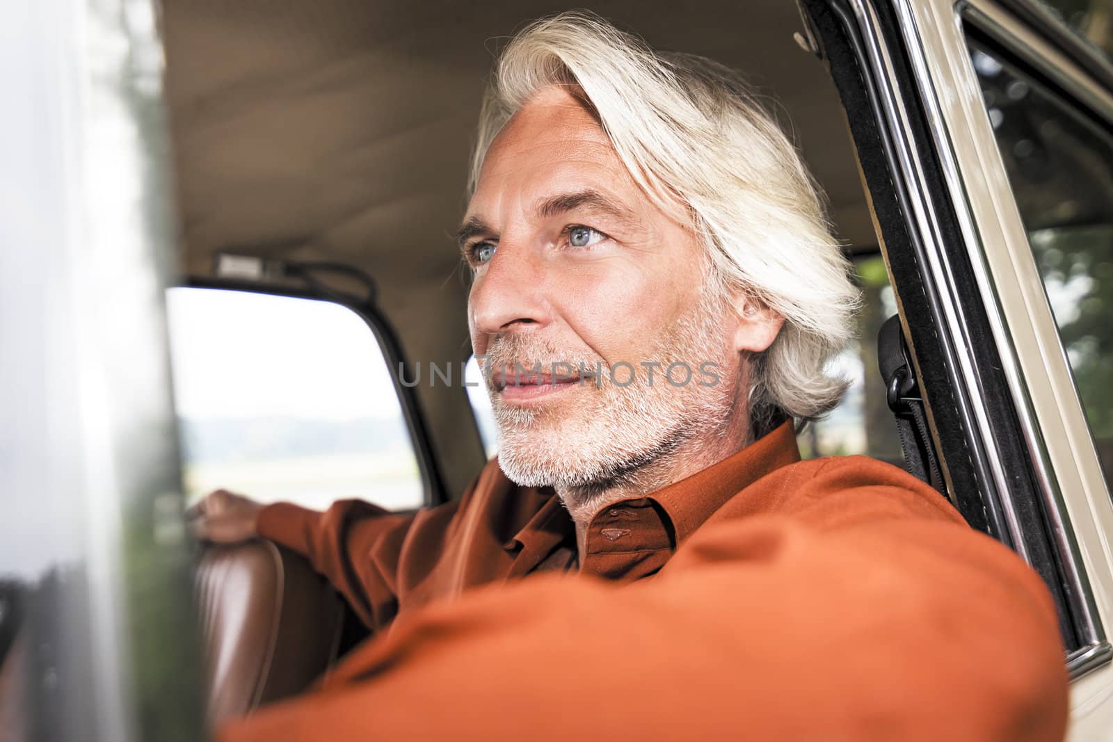 An image of a nice man in his historic car