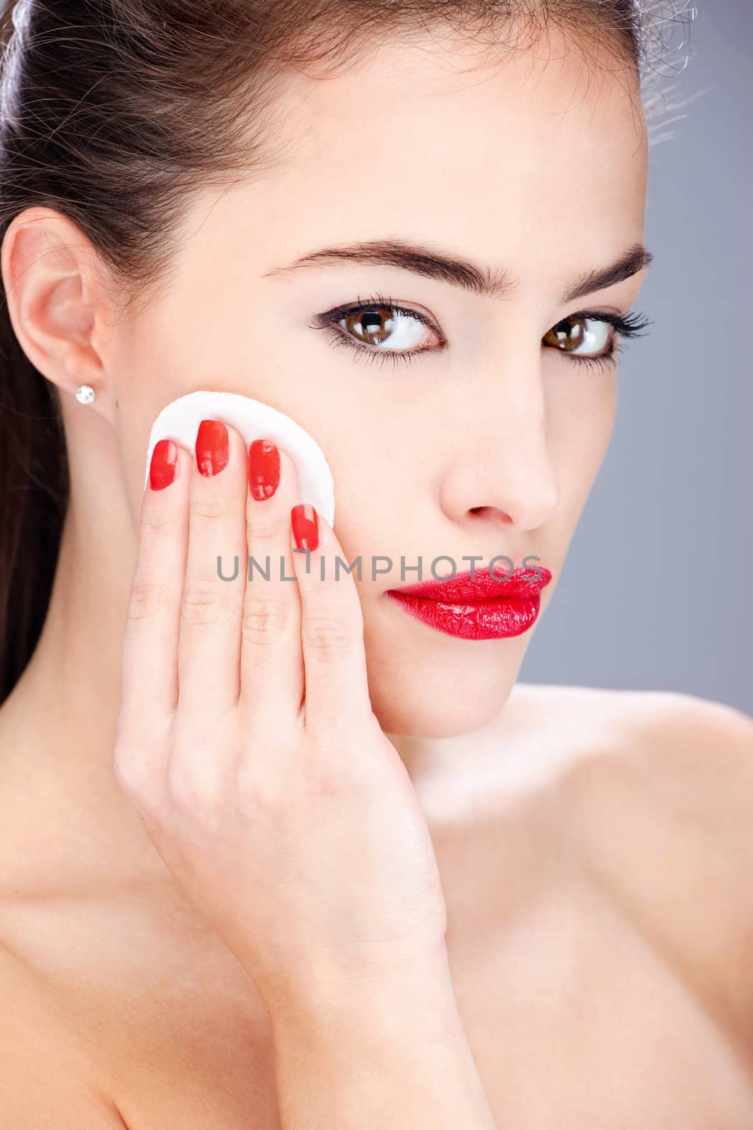 woman applying make up with sponge by imarin