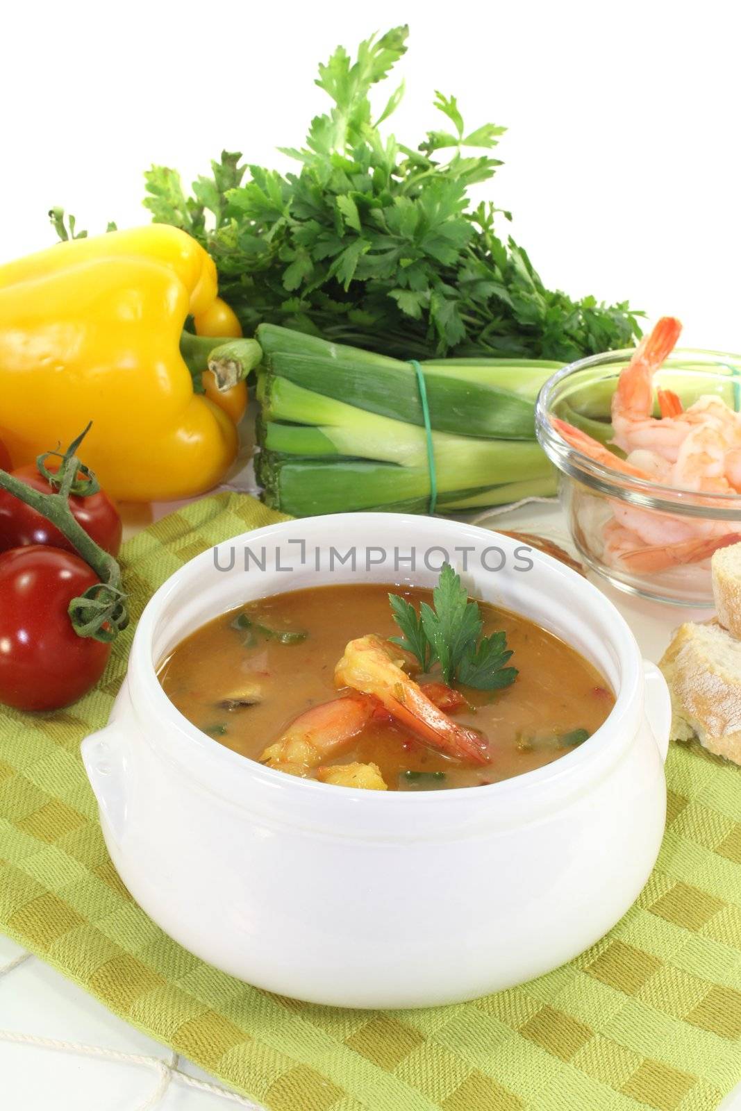 cooked bouillabaisse with shrimp and parsley on a light background