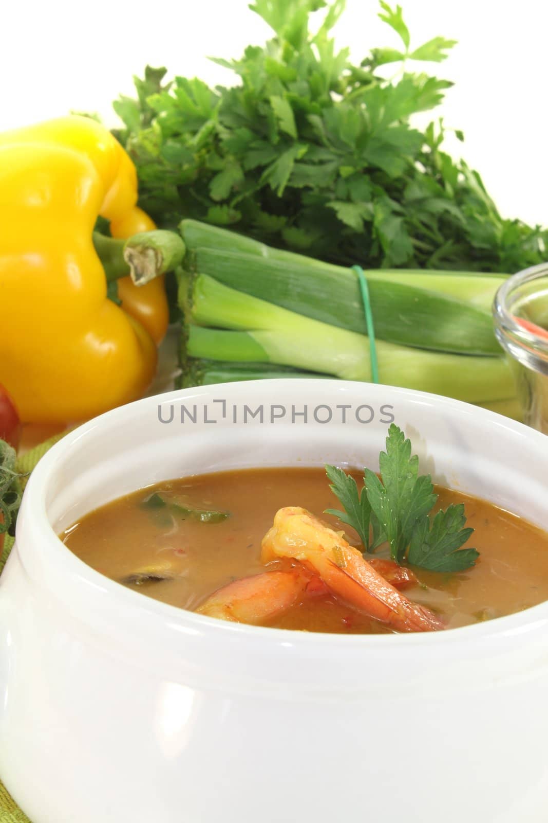 fresh cooked bouillabaisse with shrimp and parsley on a light background