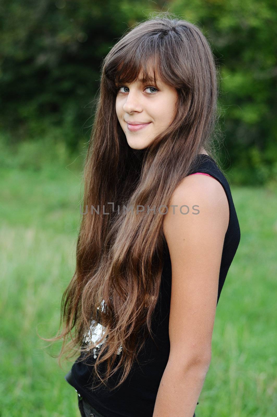 Brunette teen girl on nature by olgavolodina