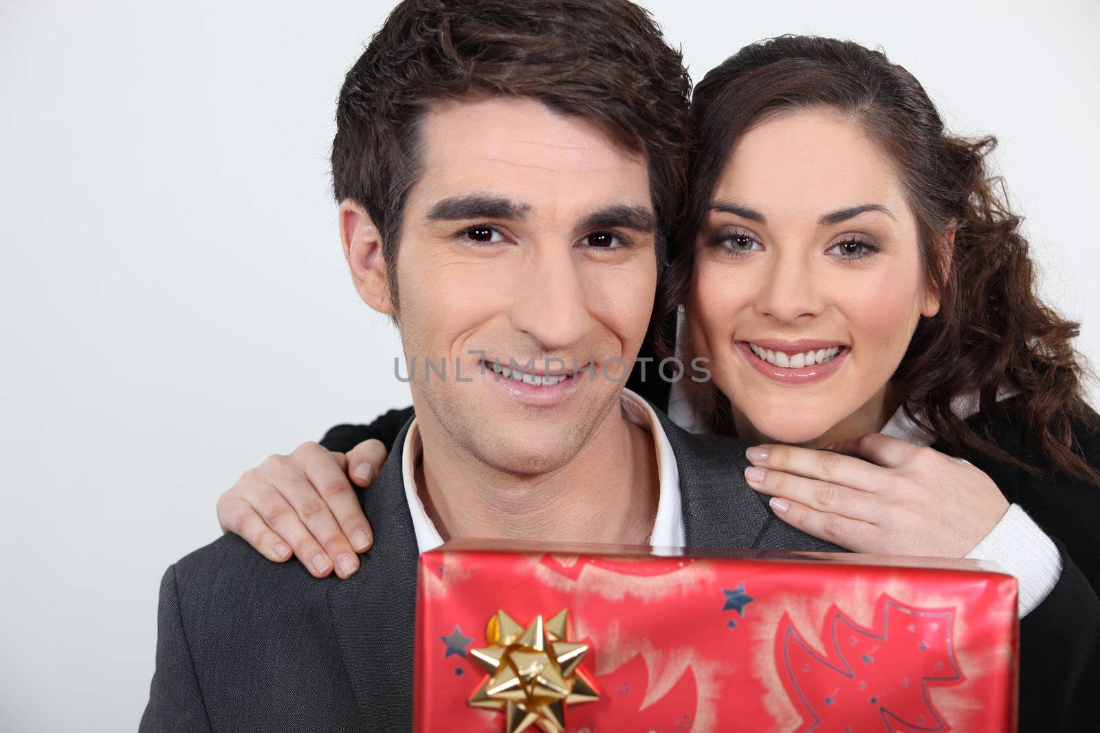 Man receiving a present from his girlfriend by phovoir