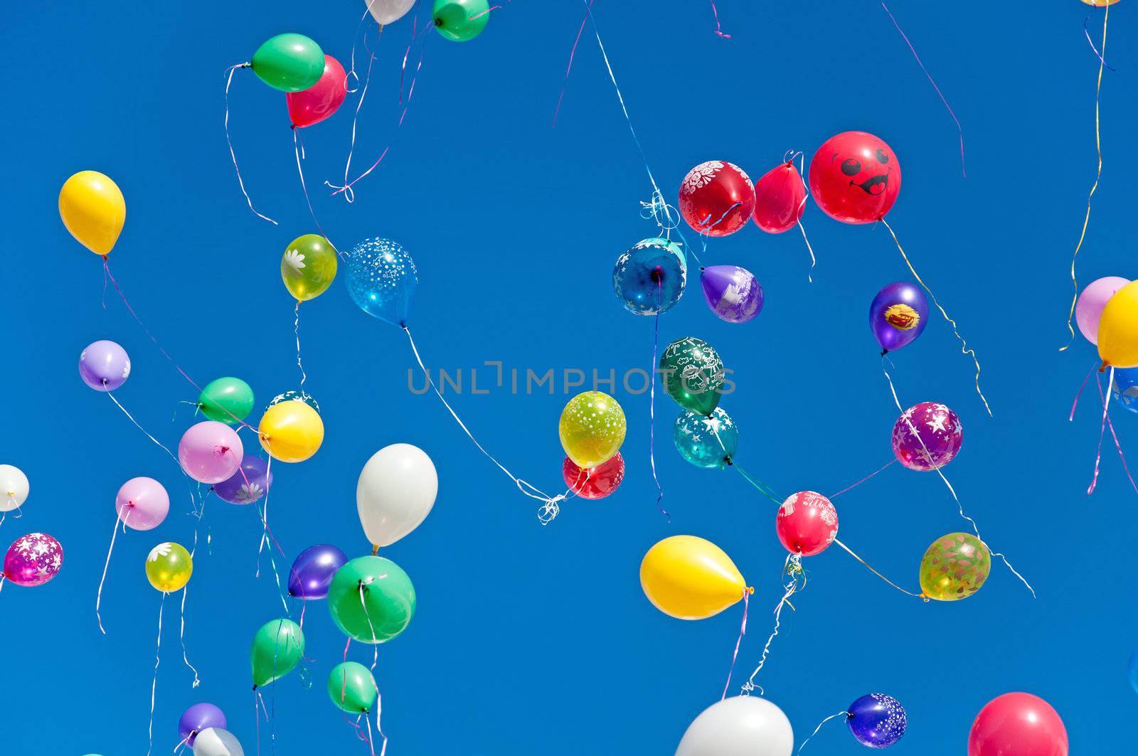 Colorful balloons on a blue sky background by olgavolodina